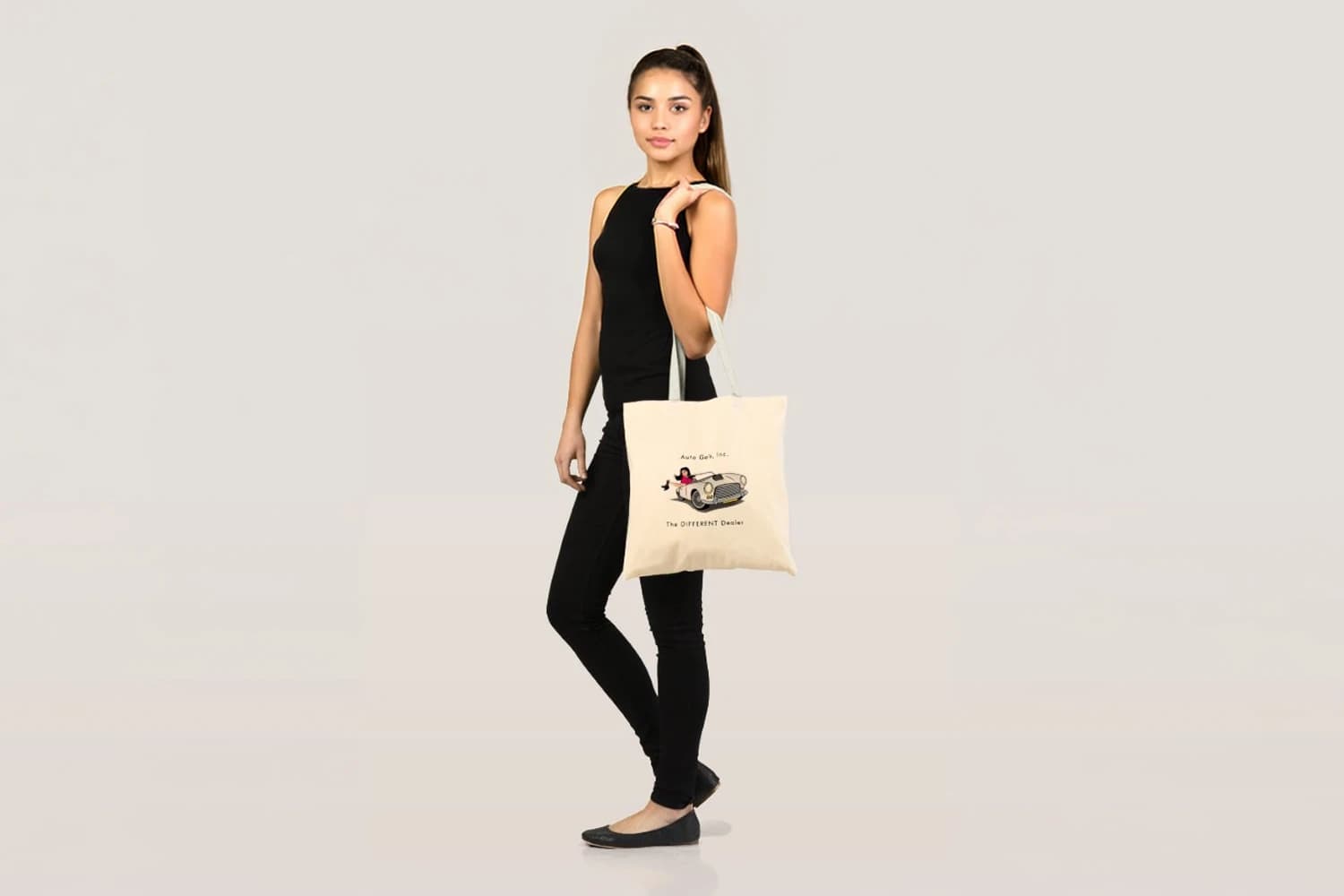 Model carrying a branded tote